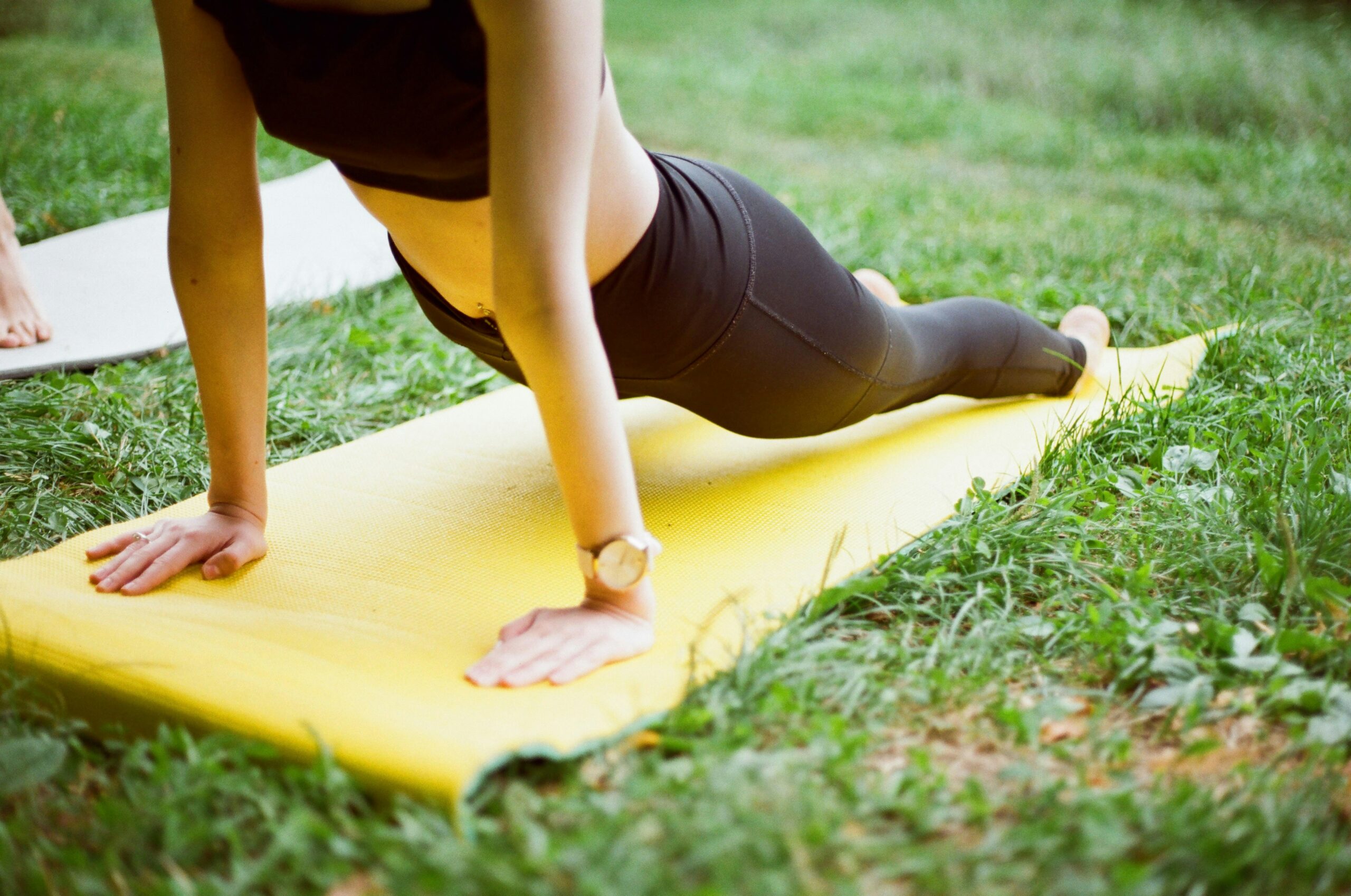 woman-doing-yoga-on-a-mat-outside