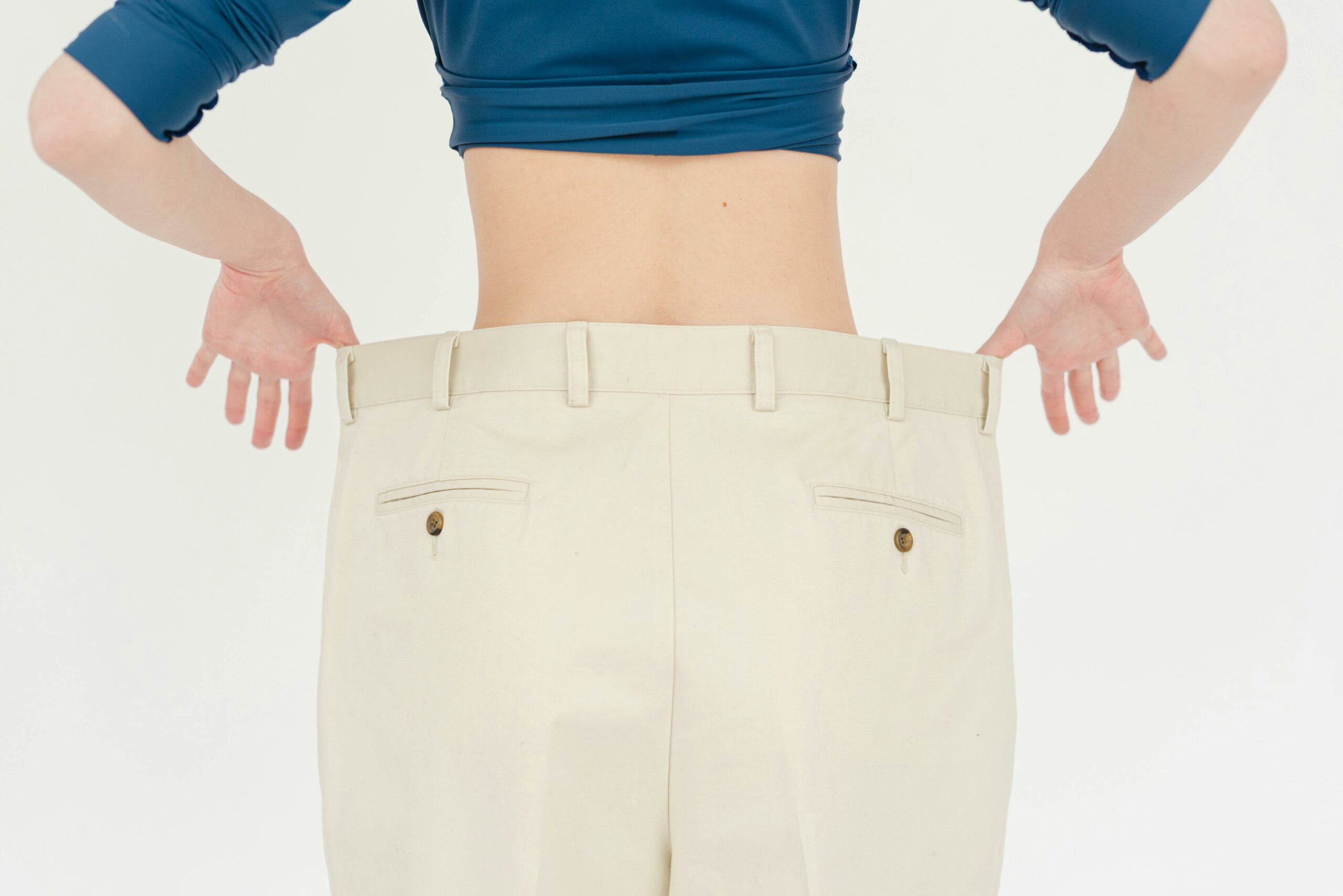 woman-pulling-large-pants-out